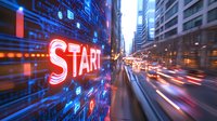 Glowing red neon start sign on digital wall with motion blur city street background showing light trails and urban buildings at dusk.