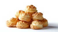 Fresh cream puffs with golden brown pastry shells stacked together, filled with vanilla custard cream on white background, isolated for food packaging and menu design.