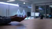 Hand holding holographic family figures in modern office space representing insurance protection and financial security services.