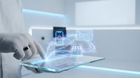 Architect engineer holding transparent tablet displaying holographic building plans and digital construction blueprints for architectural design and development projects.