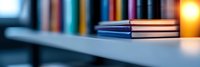 Stack of books on wooden table with soft blurred background and warm glowing light, creating peaceful study atmosphere for education and learning concepts.