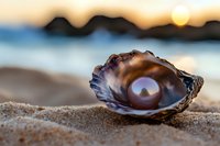 Pearl in open oyster shell on sandy beach at sunset, with blurred ocean and sun in background creating magical natural lighting and dreamy atmosphere.