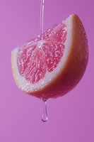 Fresh grapefruit slice with water drop falling on purple background, close-up macro shot showing juicy pulp texture and citrus segments in vibrant colors.