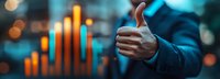 Businessman showing thumbs up gesture against financial chart with growing trend and bokeh lights background, success concept in business.