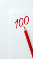 Red pencil writing number 100 on white paper background for education, grading, scoring, achievement and academic success concepts.