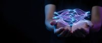 Holographic diamond floating above cupped hands with glowing purple and blue light effects on dark background for luxury technology concepts.