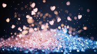 Romantic glowing hearts bokeh on dark background with pink and blue sparkles, magical love concept for Valentine's Day and wedding designs.