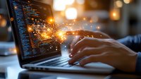 Software developer typing on laptop with glowing code and magical light effects emerging from screen, symbolizing digital transformation and programming innovation.