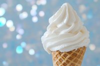 Vanilla soft serve ice cream in waffle cone against dreamy bokeh background for summer dessert menu and frozen treat advertising.