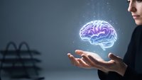 Professional businesswoman holding glowing digital brain hologram representing artificial intelligence, machine learning and innovative technology solutions.