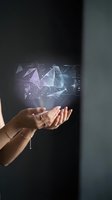 Woman's hand holding glowing digital hologram with abstract technology interface, data visualization, and geometric shapes on dark background for innovation and tech concepts.