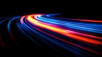 Vibrant light trails curve along dark background creating dynamic motion effect with blue, red and yellow streaks, abstract long exposure photography for technology concepts.