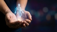 Glowing human hologram floating above cupped hands representing healthcare technology, medical innovation, digital health solutions and futuristic medicine concepts.