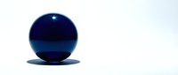Blue glossy sphere with reflection on white background for modern design projects and presentations.