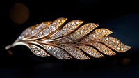 Elegant gold leaf brooch with sparkling crystals on dark background, luxury jewelry accessory for fashion and style projects.