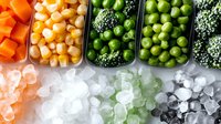 Fresh frozen vegetables and corn kernels on crushed ice, overhead view of healthy food ingredients in meal prep containers for cooking or storage.