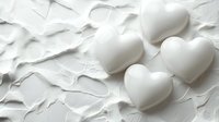 White ceramic heart shapes on crumpled paper background for romantic Valentine's Day wedding anniversary love concept design projects and greeting cards.