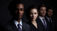 Professional diverse business team in formal attire standing in dramatic lighting against dark background, portraying leadership and corporate success.