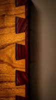 Close-up detail of interlocking wooden dovetail joints showcasing traditional craftsmanship and precision woodworking techniques in warm natural tones.