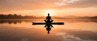 Silhouette of a person meditating in lotus pose on a paddleboard at golden sunrise over calm lake, reflection on water.