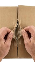 Caucasian male hands tearing open corrugated cardboard box along center seam, revealing wavy kraft paper interior. Useful for shipping, delivery, unboxing, and packaging concepts.