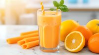 Fresh orange and carrot smoothie in tall glass with mint garnish and yellow straw, surrounded by whole citrus fruits and raw carrots, perfect for healthy lifestyle blogs.