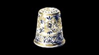 Decorative sewing thimble with blue and gold floral pattern, isolated on transparent background, ready for clipart, stickers, t-shirt design, and print on demand use.