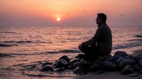 Man meditating on rocky beach at sunset with ocean waves and flying birds creating peaceful mindfulness scene for wellness and spiritual practice.