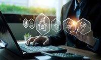 Businessman touching digital innovation icons while working on laptop in modern office environment showcasing technology and business growth concepts.