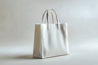 White tote bag with handles isolated on neutral background, ready for branding, mockup design, retail packaging, fashion merchandising, and commercial product presentation.