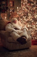 Exhausted Santa Claus resting in armchair beside glowing Christmas tree in cozy living room with festive decorations and warm lighting.