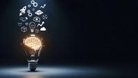Glowing light bulb with brain inside emitting business innovation icons on dark background for creative thinking and entrepreneurship concepts.