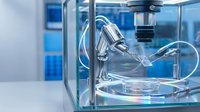 Automated laboratory equipment with robotic arm dispensing liquid sample into petri dish for scientific research and pharmaceutical testing in modern lab.