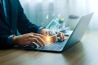 Professional businessman typing on laptop with glowing email and communication icons overlay for digital marketing and business correspondence concepts.