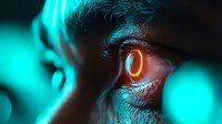 Close-up macro shot of human eye with glowing orange cybernetic lens effect against dark background with teal bokeh lights, representing future technology concept.