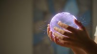 Hands holding glowing purple brain with electrical sparks representing artificial intelligence, neuroscience research, mental health awareness and cognitive science concepts.