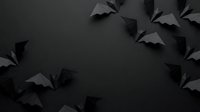 Black paper bats flying on dark background creating spooky Halloween atmosphere with copy space for seasonal decorations and party invitations.