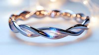 Elegant twisted silver ring with delicate braided design and soft blue reflections on light blurred background, showcasing fine jewelry craftsmanship and modern style.