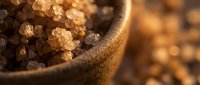 Brown sugar crystals in rustic bowl with warm lighting, suitable for food photography, baking content, culinary blogs, recipe illustrations, and ingredient close-ups.
