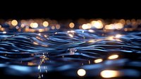 Rippling water surface with golden bokeh lights reflecting at night creating mesmerizing pattern of waves and glowing circles in dark blue tones.