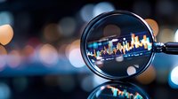 Financial market analysis through magnifying glass showing stock chart with colorful candlesticks on dark background with bokeh lights and reflection.