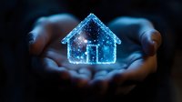 Glowing blue holographic house floating above cupped hands against dark background, representing smart home technology, real estate innovation and digital transformation.