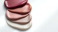 Cosmetic makeup foundation cream swatches in nude pink tones on white background for beauty and skincare product advertising campaigns.