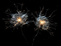 Glowing neural network visualization with interconnected nodes and light pathways against black background, representing artificial intelligence or brain connectivity.
