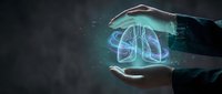 Businessman hands protecting holographic lungs with digital interface elements representing respiratory health technology and medical innovation in healthcare industry.