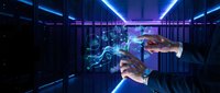 Businessman hands holding holographic digital network in futuristic data center with glowing blue server racks and advanced technology visualization.