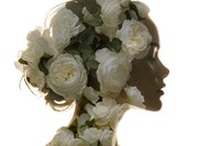 Woman silhouette profile with white roses forming hair and neck area on light background for romantic design projects and feminine concepts.