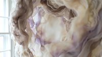 Ethereal flowing fabric with soft purple and beige tones creating dreamy waves near window light for interior design and textile concepts.