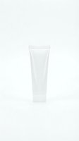 White cosmetic tube isolated on light background for skincare product packaging and beauty brand marketing materials.