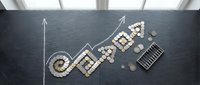 Business growth concept with wooden blocks spelling GROWTH, calculator and coins on dark slate surface with upward trending arrow chart for financial success.